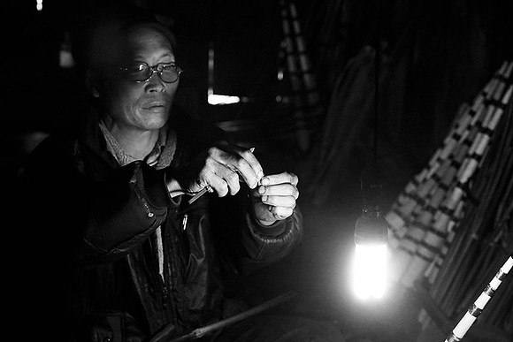 Man making traditional musical instruments