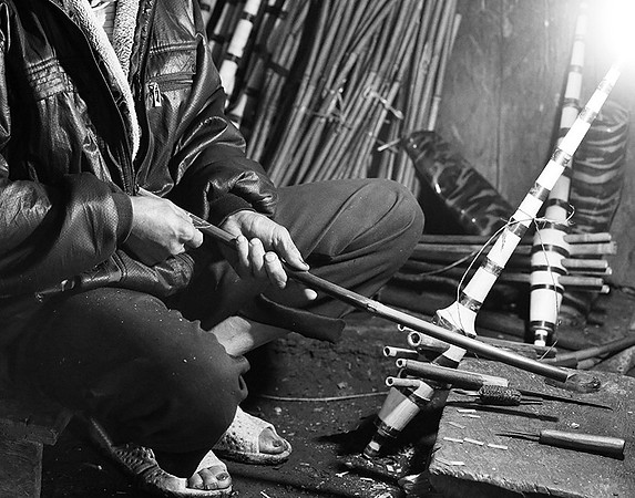 Man making traditional musical instruments