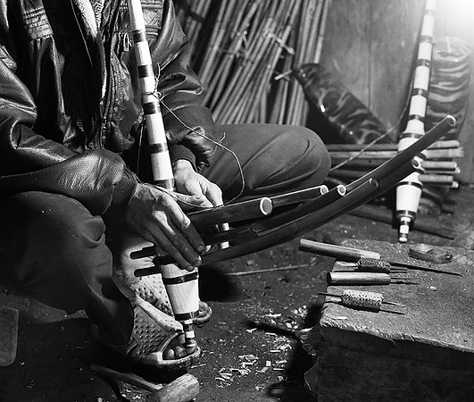 Man making traditional musical instruments